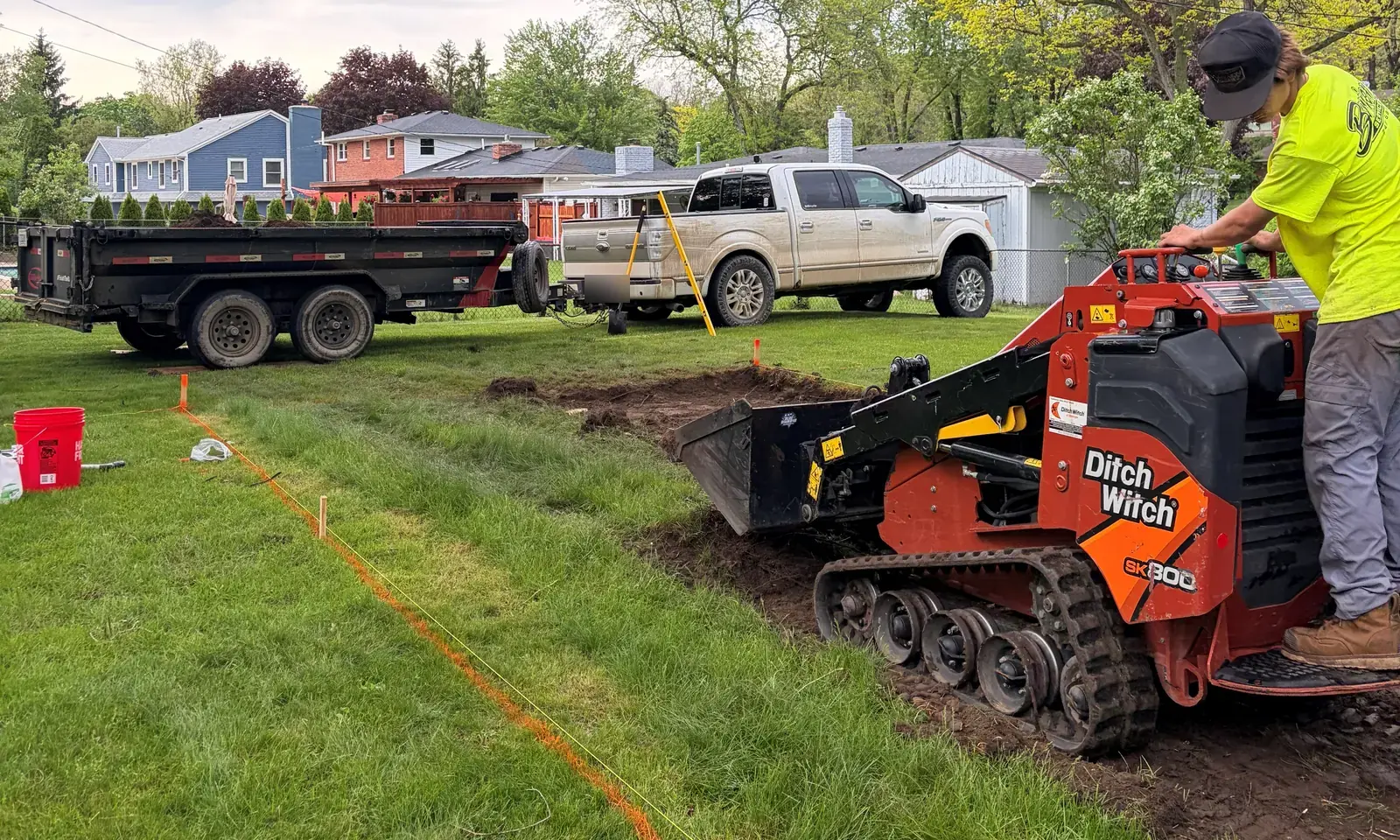 D1 crew cutting sod to a staked line with a compact track loader, Clarkston